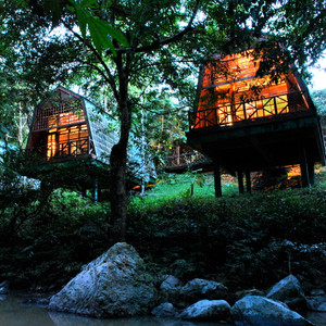 Tabin River Lodge chalets lit up at night, Tabin Wildlife Reserve, Sabah, Borneo