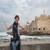Traveller at the seafront walls of the Citadel of Qaitbay, Alexandria, Egypt