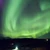 Green aurora borealis filling the night sky over the Icelandic countryside