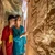 Travellers studying hieroglyphic wall carvings on a temple wall, Egypt