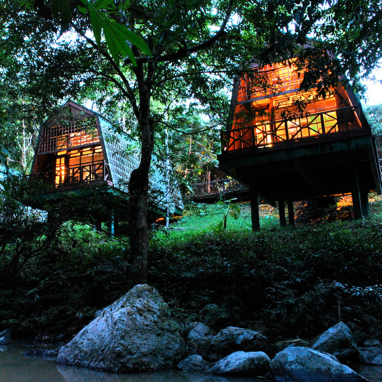 Tabin River Lodge chalets lit up at night, Tabin Wildlife Reserve, Sabah, Borneo