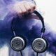Grado SR325X Prestige Headphones in hand with purple smoke