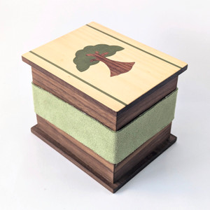 Walnut deck box for collectible card games. Marquetry lid featuring earth/forest/green design.
