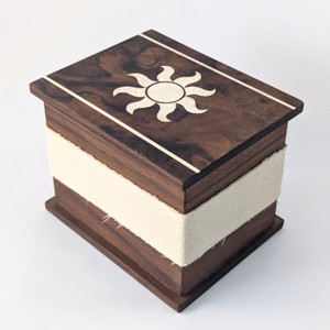 Walnut deck box for collectible card games. Marquetry lid featuring sun/plains/white design. Walnut deck box for collectible card games. Marquetry lid featuring sun/plains/white design.