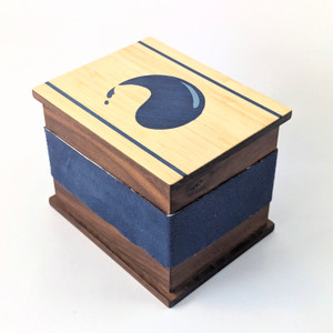 Walnut deck box for collectible card games. Marquetry lid featuring water/island/blue design. Walnut deck box for collectible card games. Marquetry lid featuring water/island/blue design.