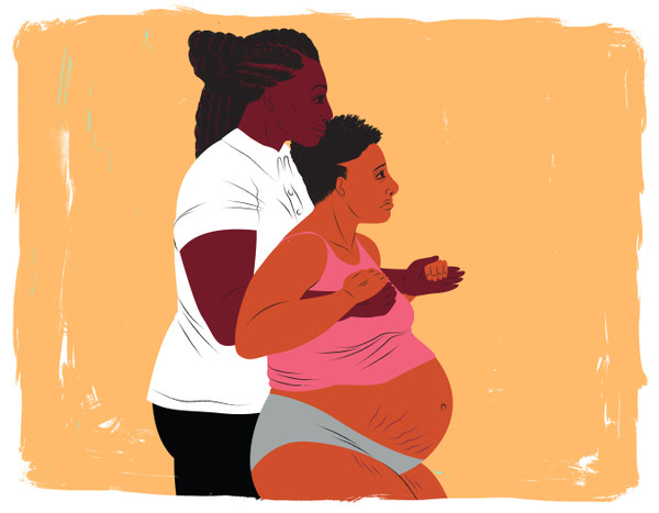 Doula supporting a standing mother during labor