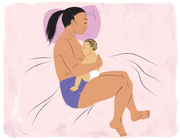 Breastfeeding in bed on side and curled