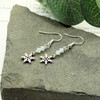 Snowflake and crystal silver earrings featuring intricate snowflake designs adorned with sparkling crystals. Elegant winter-themed jewelry for a touch of seasonal charm and sophistication