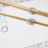 Set of fifteen cat-themed open ring removable stitch markers for knitting, featuring colourful rings, designed for easy marking of stitches in knitting projects.