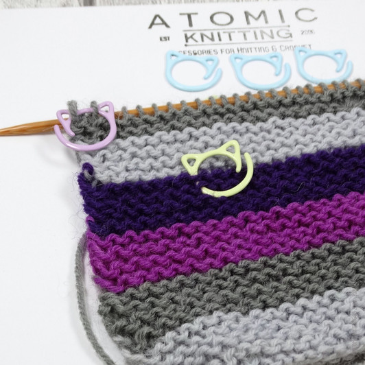 Set of fifteen cat-themed open ring removable stitch markers for knitting, featuring colourful rings, designed for easy marking of stitches in knitting projects.
