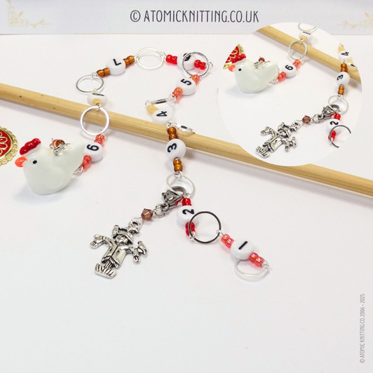 Chicken and scarecrow row counter with colourful beads for an eye catching row counter chain. Displayed over a bamboo knitting needle.