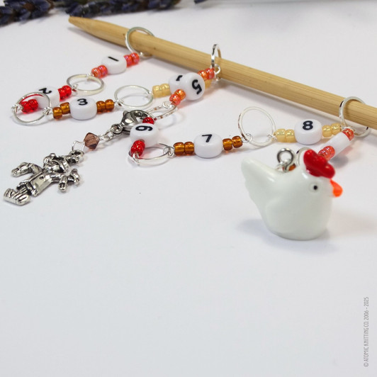 Chicken and scarecrow row counter with colourful beads for an eye catching row counter chain. Displayed over a bamboo knitting needle.