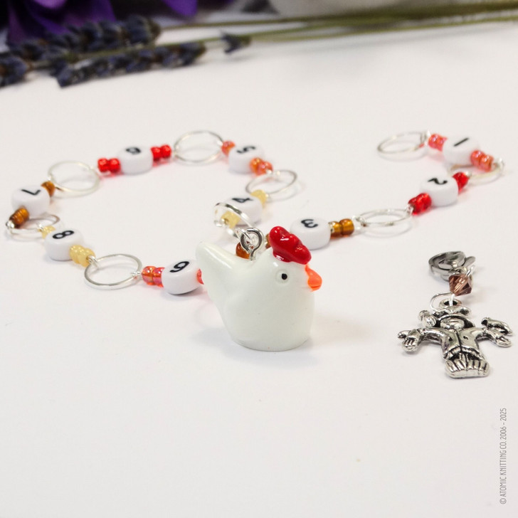 Chicken and scarecrow row counter with colourful beads for an eye catching row counter chain. Displayed on a white background.