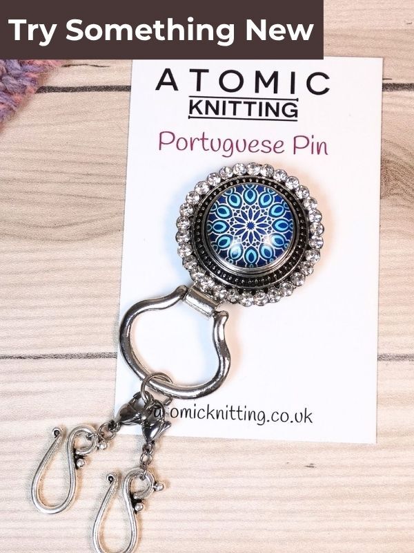 A magnetic portuguese knitting pin with double hooks on a backing card