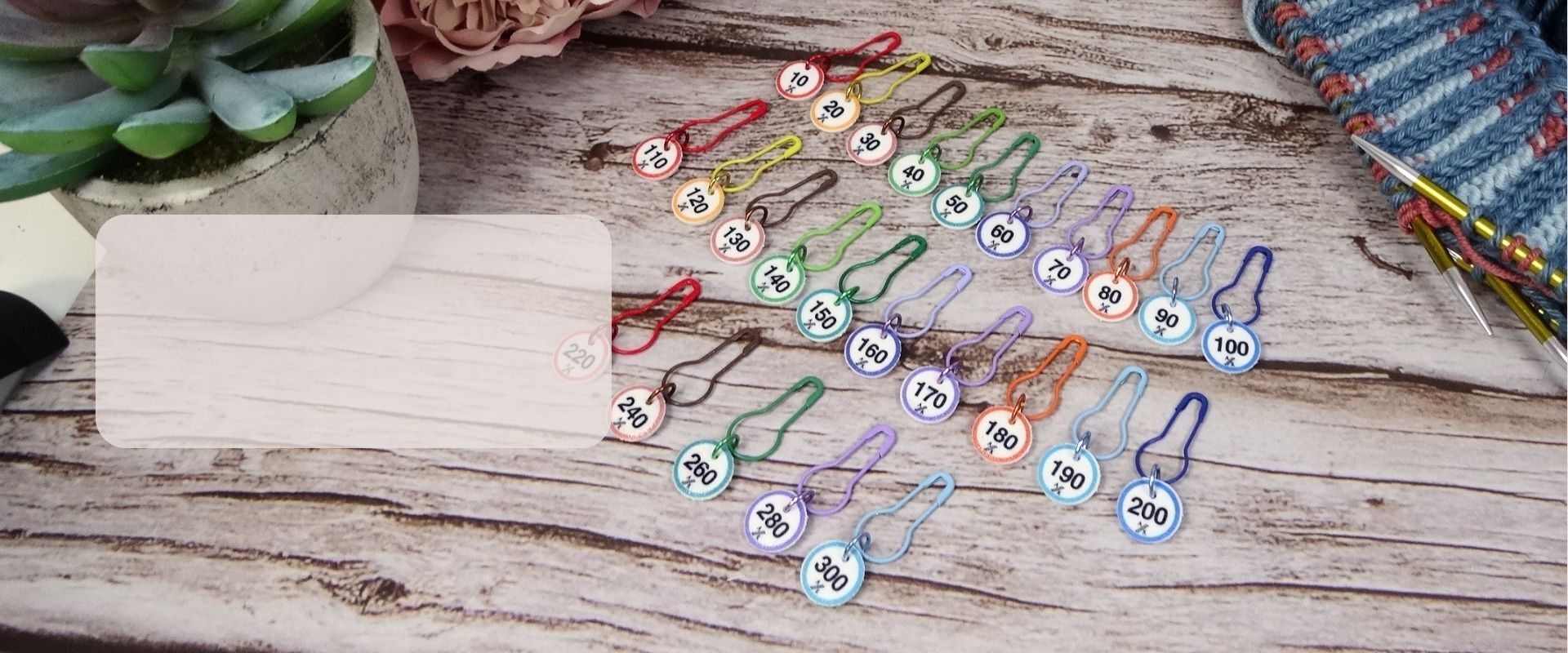 Numbered stitch markers for knitting with colourful discs and knitters pin