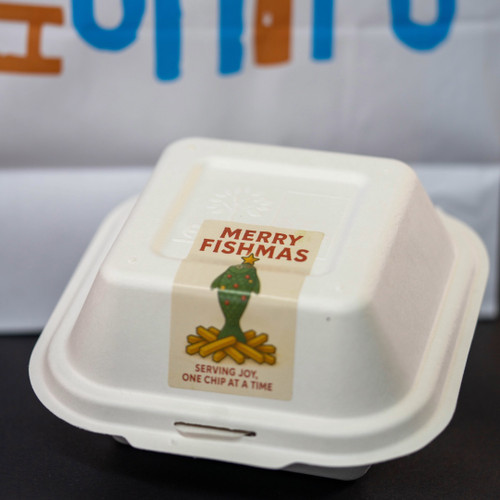 Merry Fishmas Label on a bagasse clamshell Merry Fishmas Label on a bagasse clamshell
