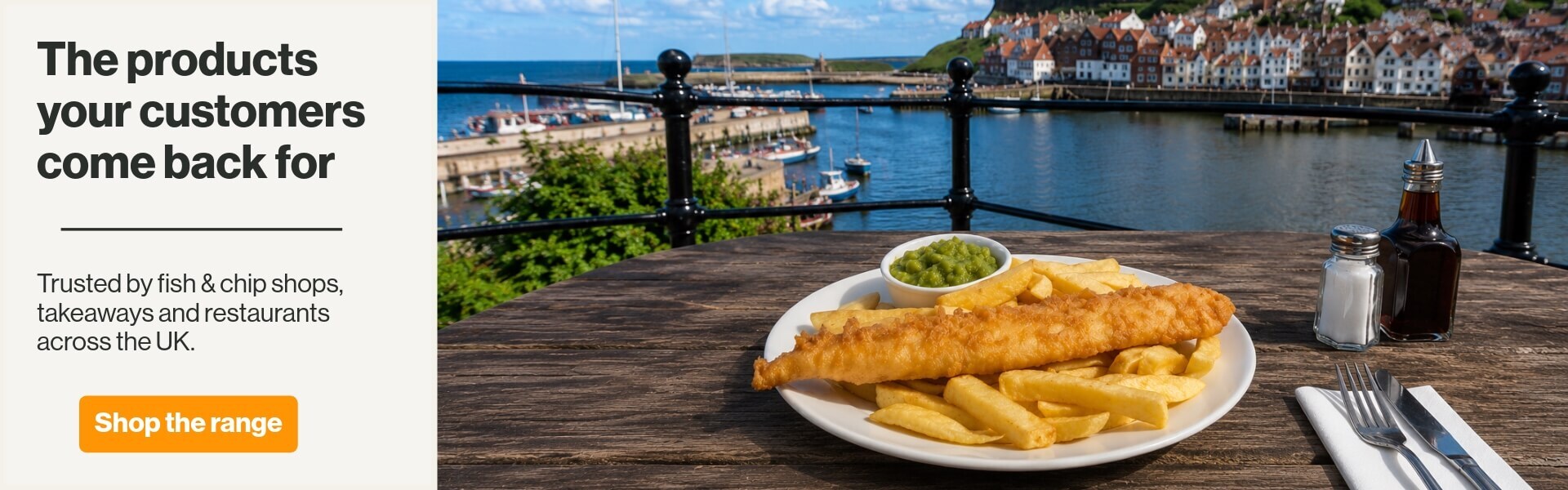 fish & chips hero image on a restaurant table outside looking at the harbour