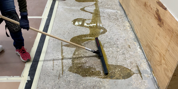 applying moisture-sealing epoxy primer