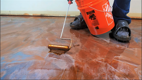 applying epoxy to floor surface