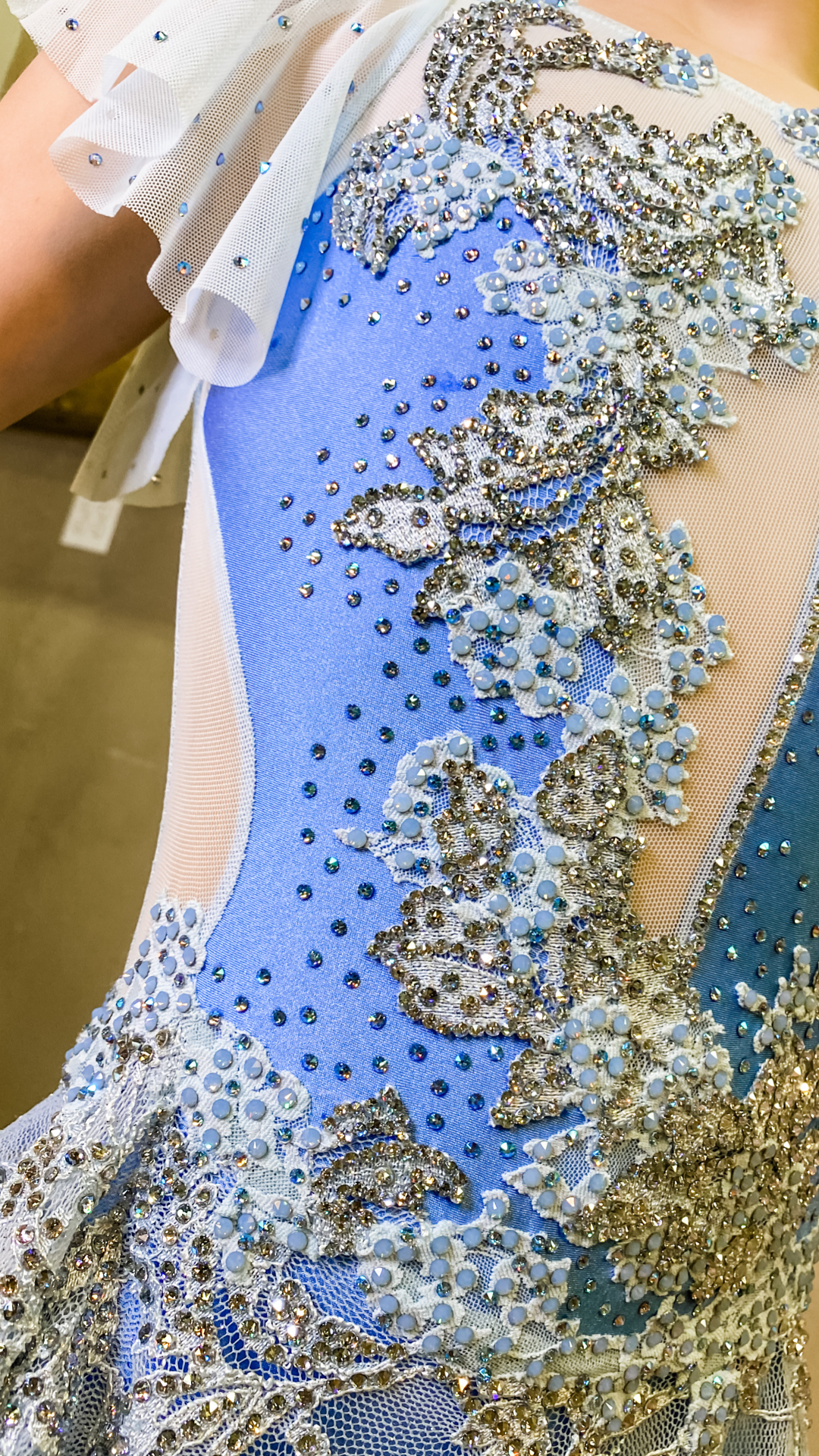 Hand holding a crystal-embellished handbag