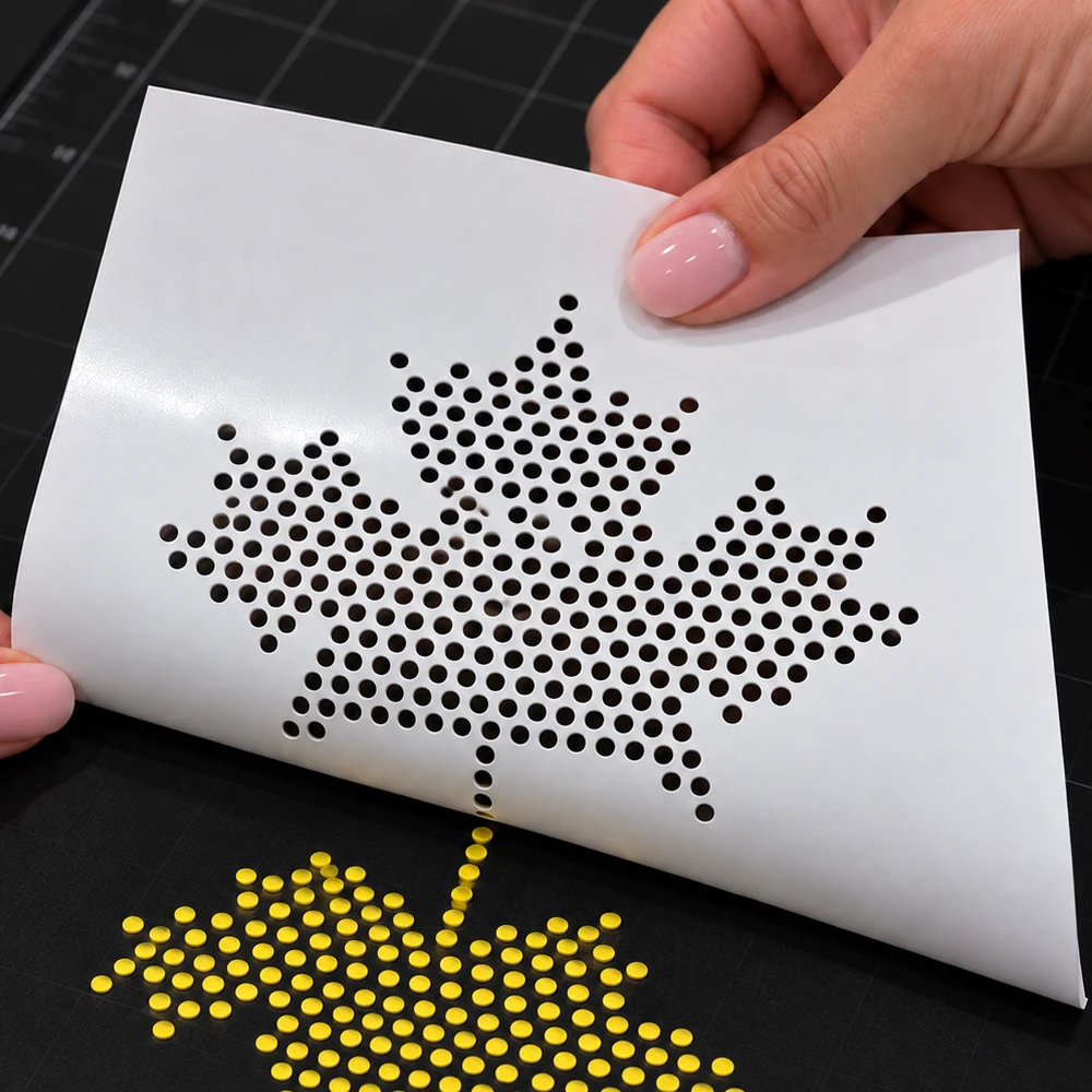 Removing small circular chads from yellow rhinestone template flock