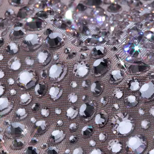 Silver rhinestones in Preciosa's Mesmera color densely set on fabric