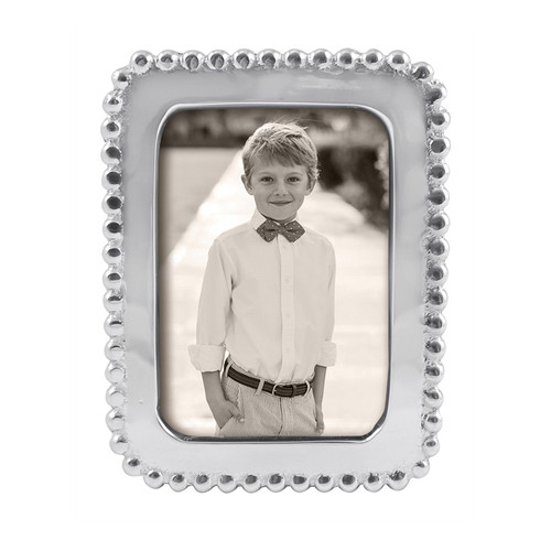 Display school pictures or other wallet-size snapshots in the Beaded 2 x 3 Frame. Handcrafted from sparkling, 100% recycled aluminum.
Recycled Sandcast Aluminum
DETAILS & PRODUCT CARE
Dimensions: 4.5in L x 3.5in W
Product Care:
Our fine metal is handcrafted from 100% recycled aluminum.
All items are food-safe and will not tarnish.
Handwash in warm water with mild soap and towel dry immediately.
Do not place in dishwasher or microwave.
Avoid extended contact with water, salty or acidic foods; coat lightly with vegetable oil or spray to easily avoid staining.
Warm to 350 degerees for hot foods. Freeze or chill for summer entertaining.
Cutting directly on the metal surface will scratch the finish.
Occasional use of non-abrasive metal polish will revive luster.
Photo Opening Size: 2 x 3