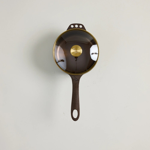 Smithey 1Qt Saucepan

Smith-CI-Sauce1
Diameter (top): 6.375”
Depth: 4.125”
Cook Surface: 5”
Length (with handle): 13.375”
Volume: 1.5 Qt


Smithey created this 1-quart cast iron saucepan with a custom glass lid to round out your collection and serve as the perfect sidekick for meals that call for sauces, roux, gravies, and more. Its depth makes it ideal for indulgent side dishes like butter-poached potatoes and fried green beans. The lid locks in warmth, allowing you to move seamlessly from stovetop to tableside to serve decadent confits, spicy chili crisps, or savory sauces to your guests. It’s a perfect addition to your Smithey kitchen and an essential companion when cooking.  This saucepan comes pre-seasoned, meaning it’s ready to use right out of the box. To break it in, start with side dishes and rich sauces that incorporate butter or other fats. While it may seem like an ideal rice pot, we do not recommend using this saucepan for boiling water