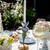 Juliska Meadow Walk Iris 9" Candlestick - Chambray

TDM04
3.75"D, 9"H

Spring is permanently sprung with this enchanting Iris Candlestick that brings elegance, joy, and a touch of whimsy to any tablescape. Made of intricately hand-painted metal in dreamy chambray hues upon a bright gold base that’s trimmed with our iconic Berry & Thread motif.

Metal.  Clean with damp cloth.