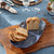 Juliska Le Panier Mystic Knot 15" Hostess Tray - Denim

KHM54/46
15"L, 8.5"W

The endless loop of this hostess tray is richly textural and forever chic. Symbolizing protection, love, and a long, happy life—the mystic knot has been cherished for generations by sailors as a tribute to their families and the sea—making this sculptural piece perfect for gifting to loved ones, or to keep for yourself to serve everything from freshly baked muffins to sunglasses to vintage postcards.