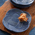 Juliska Le Panier Mystic Knot Dessert/Salad Plate - Denim

KHM02/46
9" D

Symbolizing protection, love, and a long, happy life, the mystic knot has been cherished for generations by sailors as a tribute to their families and the sea. With its interwoven braided whorls in versatile deep blue hue, this dessert/salad plate brings rich textural warmth, a sculptural silhouette, and a timeless aesthetic to any table setting.