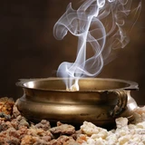 Smoke rising from a brass bowl over resin granules — scent inspiration for Frankincense & Myrrh fragrance oil