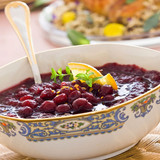 Dark cranberry sauce in an ornate bowl with orange slice — scent inspiration for Cranberry Chutney fragrance oil