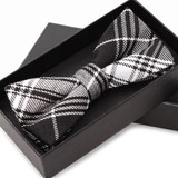 Black and white plaid bow tie in a gift box — scent inspiration for Burberry Brit fragrance oil