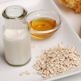 Milk bottle, dish of honey, and oats on a white tray — scent inspiration for Oatmeal, Milk & Honey fragrance oil