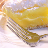 Slice of lemon meringue pie with fork on white plate — scent inspiration for Lemon Chiffon fragrance oil