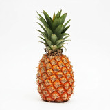Whole pineapple with green crown on white — scent inspiration for Pineapple fragrance oil