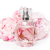 faceted glass perfume bottle among pink roses — scent inspiration for Flowerbomb fragrance oil