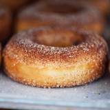 Cinnamon-sugar coated donut on parchment — scent inspiration for Cinnamon Sugar Donuts fragrance oil
