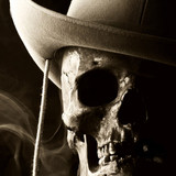 Human skull wearing a hat against a dark smoky background — scent inspiration for Desperado fragrance oil