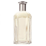 Tall clear cologne bottle with silver cap, pale yellow liquid — scent inspiration for Tommy fragrance oil