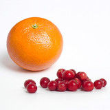 Orange and small red cranberries on white — scent inspiration for Mandarin Cranberry fragrance oil