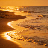 golden sunset over ocean waves on a beach — scent inspiration for Golden Hour fragrance oil