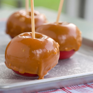 Caramel-coated apples on sticks on a metal tray — scent inspiration for Caramel Apple fragrance oil