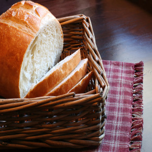 Loaf of sliced white bread in a wicker basket — scent inspiration for Fresh Baked Bread fragrance oil