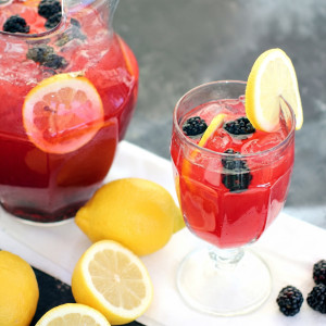 Red iced drink with lemon slices and blackberries, pitcher — scent inspiration for Blackberry Lemonade fragrance oil