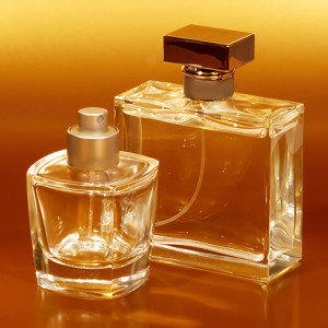 Two glass perfume bottles against glowing amber background — scent inspiration for Amber Vanilla fragrance oil