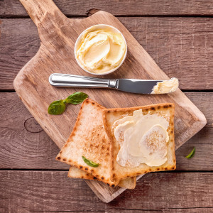 buttered toast, butter dish and knife on wooden board — scent inspiration for Honey Maple Butter fragrance oil