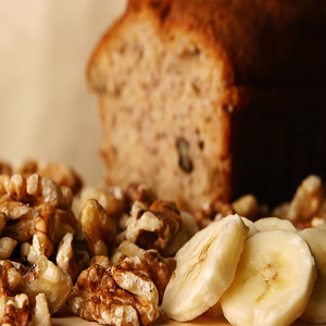 Walnuts and banana slices beside loaf of bread — scent inspiration for Banana Nut Bread fragrance oil