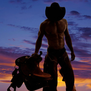 Shirtless cowboy in a hat holding a saddle at sunset — scent inspiration for Cowboy fragrance oil